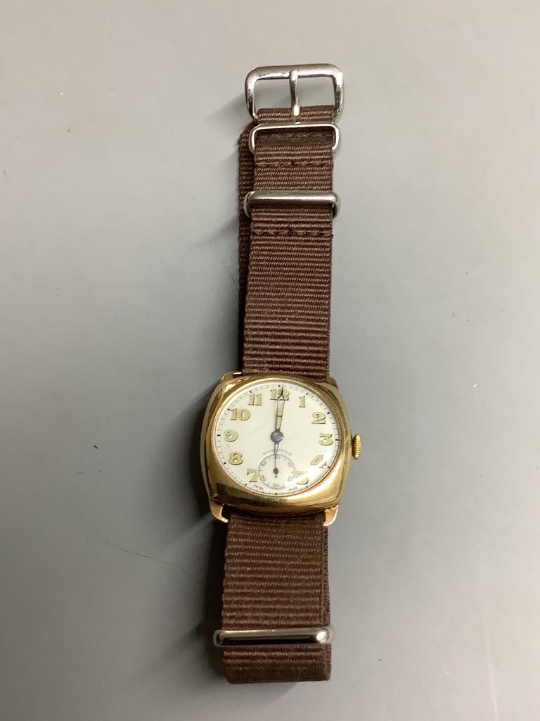 A gentleman's 1940's 9ct gold Longines manual wind wrist watch, with case back inscription, on associated fabric strap